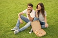 Fast food. Bearded man and woman enjoy cheesy pizza. Couple in love dating outdoors with pizza. Hungry students sharing