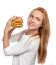 Fast food concept. Tasty unhealthy burger sandwich in hands hung Royalty Free Stock Photo