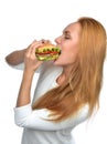 Fast food concept. Woman eating tasty unhealthy burger sandwich Royalty Free Stock Photo