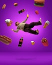 Contemporary art collage with adult overweight man levitating among junk meal, beer, cola, french potato, sandwich, hot