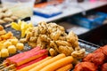 Fast food counter on the asian market kebabs with soy meat, breaded chicken selective focus Royalty Free Stock Photo
