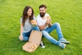 Fast food delivery. Bearded man and woman enjoy cheesy pizza. Couple in love dating outdoors with pizza. Hungry students Royalty Free Stock Photo