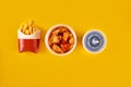 Fast food dish on yellow background. Fast food set fried chicken and french fries. Take away fast food. Royalty Free Stock Photo