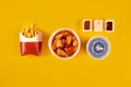 Fast food dish on yellow background. Fast food set fried chicken and french fries. Take away fast food. Royalty Free Stock Photo