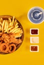 Fast food dish on yellow background. Fast food set fried chicken and french fries. Take away fast food. Royalty Free Stock Photo