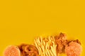 Fast food dish on yellow background. Fast food set fried chicken, meat burger and french fries. Take away fast food. Royalty Free Stock Photo