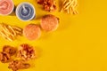 Fast food dish on yellow background. Fast food set fried chicken, meat burger and french fries. Take away fast food. Royalty Free Stock Photo