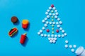 Fast food figures with Christmas tree made from pills, unhealthy food on holidays.