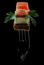 fast food on a fork, appetizer for spirits, sire on grain bread with herbs and tomato,