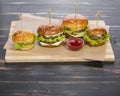 Fast food four sandwiches on a dark background. Royalty Free Stock Photo