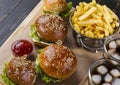 Fast food four sandwiches on a wooden table. Royalty Free Stock Photo