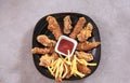 Fast food fried crispy and spicy chicken legs, wings and french fries potatoes with salt and ketchup sauce Royalty Free Stock Photo
