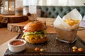 Fast Food. Hamburger. Close-up fresh delicious tasty homemade burger. This hamburger with french fries rustic wooden Royalty Free Stock Photo