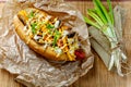 Fast food hotdog with beef sausage and fresh grilled vegetables with wheat bun on wooden background Royalty Free Stock Photo
