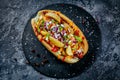 Fast food hotdog with beef sausage and fresh grilled vegetables with wheat bun on wooden background Royalty Free Stock Photo