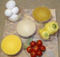 Fast food ingredients: eggs, rice, bulgur, cherry tomatoes, bay leaf, corn grits, sweet pepper Royalty Free Stock Photo