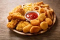 Fast food meals : onion rings, french fries, chicken nuggets and fried chicken