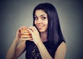 Fast food is my favorite. Woman eating a double cheeseburger Royalty Free Stock Photo