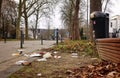 Fast food packaging polluting the ground near a garbage box due to social misbehavior