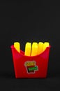 Fast food. plastic french fries on a black background