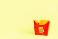 fast food. plastic french fries on a yellow background