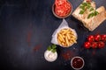 Fast food. Red bowl of french fries chips potato and sauces, doners on black background. top view, copy space Royalty Free Stock Photo