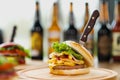 Fast food restaurant. Lots of different burgers and beer bottles on the table at the window restaurant. Royalty Free Stock Photo