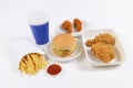 Fast food set containing burgers, fried chicken, french fries and soft drink isolated on white background Royalty Free Stock Photo