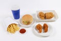 Fast food set containing burgers, fried chicken, french fries and soft drink isolated on white background Royalty Free Stock Photo