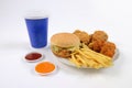 Fast food set containing burgers, fried chicken, french fries and soft drink isolated on white background Royalty Free Stock Photo