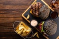 Fast food set, top view. Two grilled burgers with beef cutlet, sauce and a glass of cola and fries Royalty Free Stock Photo