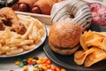 Fast food and unhealthy eating concept - close up of fast food snacks and cola drink on white table