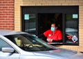 Fast food Worker wearing a safety mask .