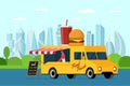 Fast food yellow truck in modern city park. Burger and beverage on van roof. Hamburger with soda car delivery service or