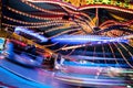 Fast funfair ride carousel at the christmas market, long exposure with blurred motion, abstract background, copy space Royalty Free Stock Photo