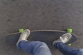 Fast longboard riding, top view with negative space. Royalty Free Stock Photo