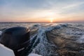 Fast motorboat ride on sea at sunset