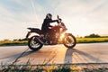 Fast motorcycle drive on asphalt road at sunset. Royalty Free Stock Photo