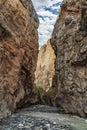 A fast mountain river flows into a mountain gorge. Nature wallpaper