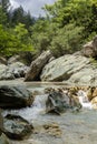 A fast mountain river flows on a overcast, summer day Peloponnese, Greece Royalty Free Stock Photo