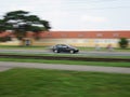 Fast moving black car with motion blur background Royalty Free Stock Photo