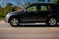 Fast moving black SUV car on the city road. Suzuki Vitara with senior man driving. 4x4 auto outside the city in motion Royalty Free Stock Photo