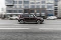 Fast moving brown car on the city road. Compact city hatchback is driving along the highway. Kia Soul on the city street in motion