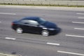 Fast moving car on a highway Royalty Free Stock Photo