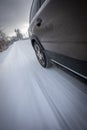 Fast moving car on a  snowy road Royalty Free Stock Photo