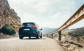 Fast-moving compact auto on the mountain road asphalt road with steel Traffic Guardrail. Traveling on Mallorca island in Spain, Royalty Free Stock Photo