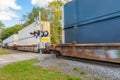 Freight train loaded with containers passing a railroad crossing on a sunny fall day Royalty Free Stock Photo