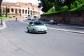 Fast moving green fiat 500