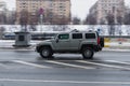 fast moving Hummer H3 SUV rides on a winter city road. A car on wet slippery road in motion. Overspeed in city concept