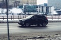 fast moving Hyundai Creta on a winter city road. Black SUV car on wet slippery street in motion. Overspeed in city concept